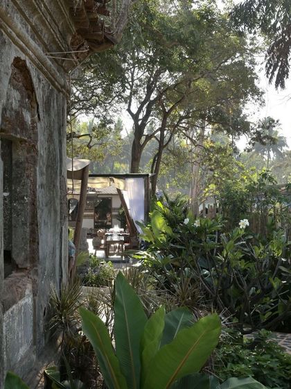A view from the ruins at Sanctuary Bar towards the open-air dining pavilion. The landscape is dense and wild, creating a sense of being completely immersed in nature.