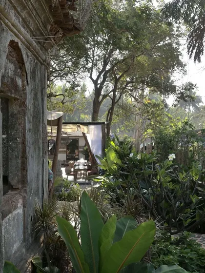 A view from the ruins at Sanctuary Bar towards the open-air dining pavilion. The landscape is dense and wild, creating a sense of being completely immersed in nature.