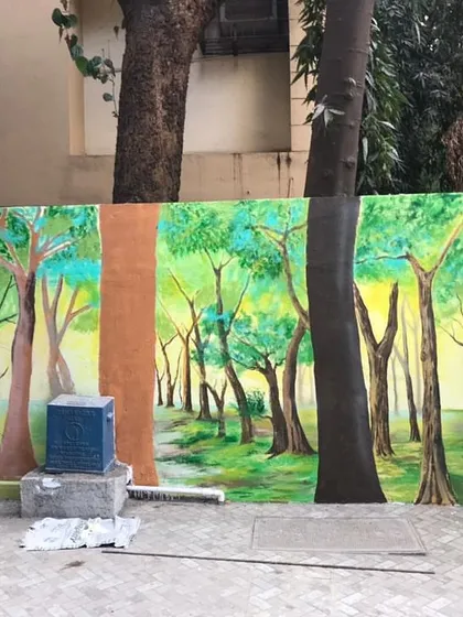 This section of the exterior project features a serene forest path, painted to blend with the real trees in front of it.