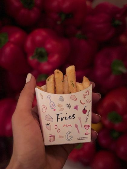 Our iconic fries, served in a custom-designed box against a backdrop of red peppers. Simple, perfect, and always in demand.