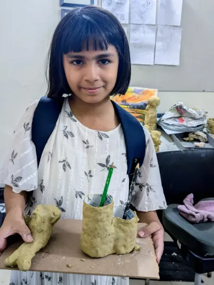 Anishkaa shows off her functional art: a creative fish sculpture and a set of pen stands, all made from papermache. It's art you can use every day.