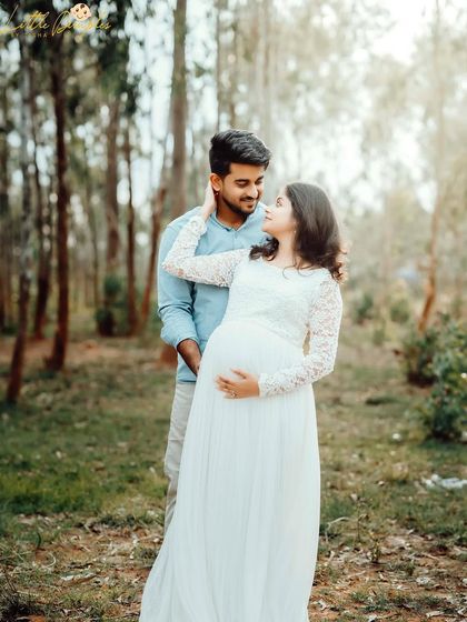 A beautiful, candid moment between an expecting couple in a serene woodland setting. Outdoor maternity sessions are perfect for capturing natural interactions.