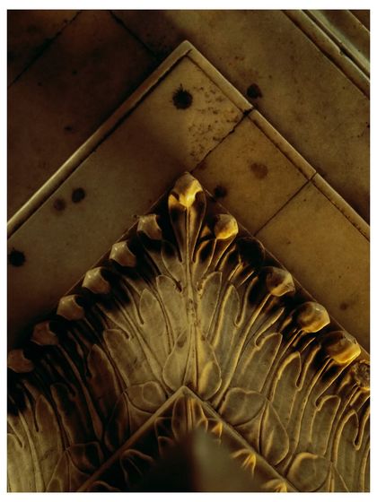 An abstract detail of the marble inlay work on the tomb's ceiling, showing the beauty in the patterns and decay.