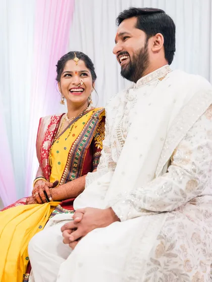 A couple sharing a laugh during their wedding ceremony.