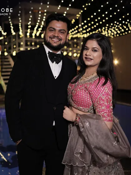 Your style, my pride. This couple looks glamorous for a cocktail night in a pink and grey lehenga and a classic black tuxedo.