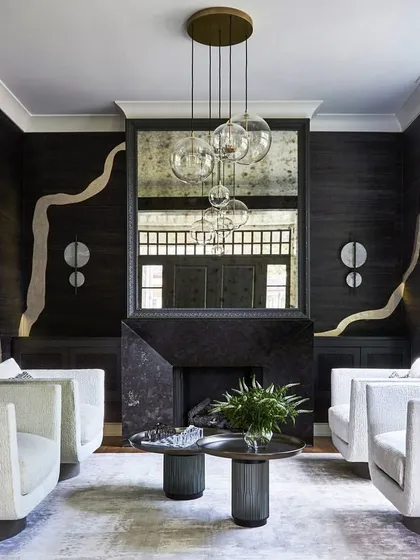 A formal and symmetrical living room arrangement featuring four elegant swivel chairs upholstered in a textured, light-colored fabric. This space demonstrates our ability to furnish grand rooms with sophisticated, custom seating solutions that promote conversation and comfort.