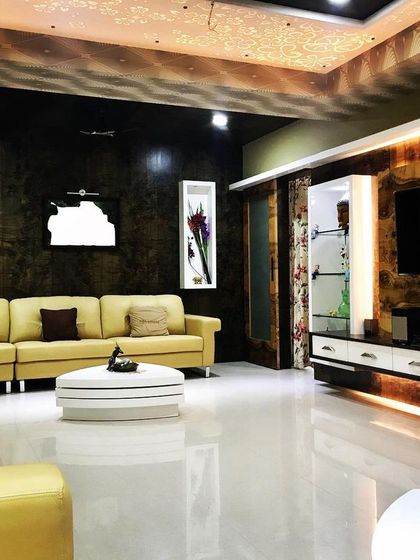 This angle of the luxurious living room shows the custom TV unit with integrated lighting and the spacious seating arrangement.