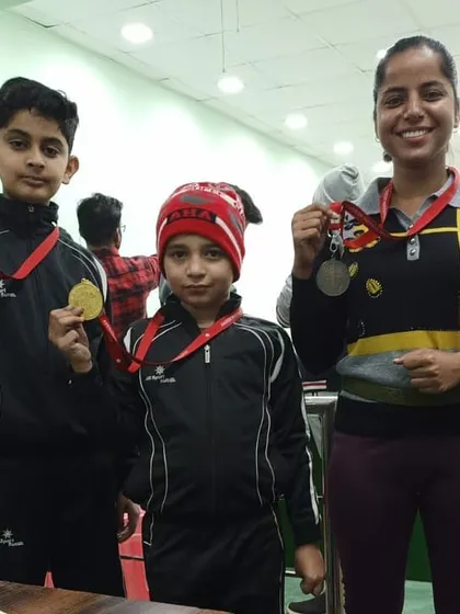Our students, both young and experienced, showing off their medals after a successful competition. We foster an environment where shooters of all ages can learn from each other.