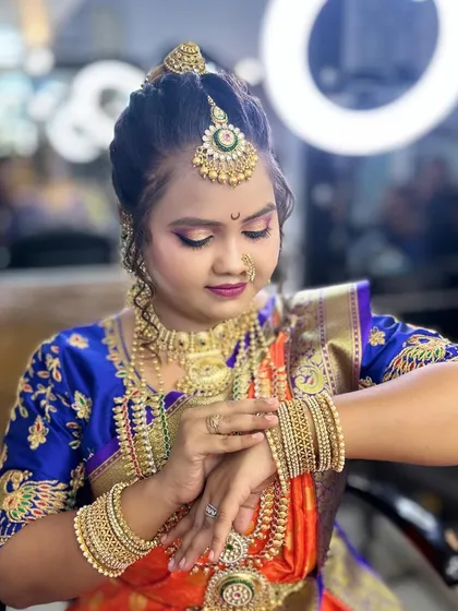 A candid moment captured during the bridal photoshoot, showing the beautiful details of the makeup and jewelry.