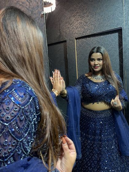 A mirror selfie in the stunning navy blue lehenga. Our clients love capturing their final look in our store.