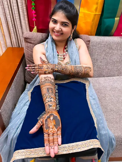 A happy client showing her custom portrait mehndi. I drew a figure of a king on her palm as part of her royal-themed design.