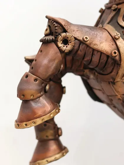 Detail of the front leg of the Steampunk Horse cake, showing the layered armor and joint details. I use various techniques to achieve the aged bronze and copper textures.