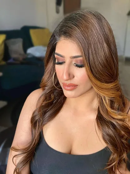 A dewy and fresh look for influencer 'The Filmy Kudi'. The focus is on luminous, sun-kissed skin and a warm, shimmering eye.