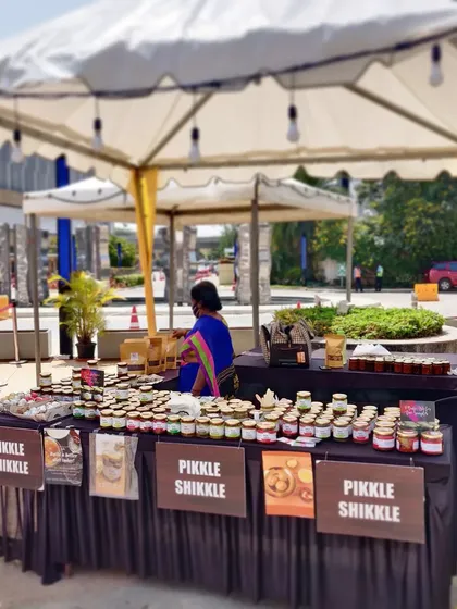 A wide shot of our Pikkle Shikkle stall under a tent at an outdoor market. We set up shop in various locations to make it easy for you to find us.