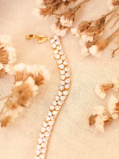 A creative product shot of the same bracelet styled with dried flowers. This type of lifestyle shot is perfect for social media and brand storytelling.