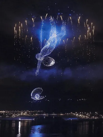 I add explosive drama to my shows with pyro drones. This display features a diver created from light, surrounded by perfectly synchronized pyrotechnic bursts, showcasing how I merge precision flight with spectacular special effects.