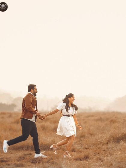 A fun, dynamic shot of the couple running through the field. Action shots like this add energy and a sense of playfulness to your pre-wedding album.