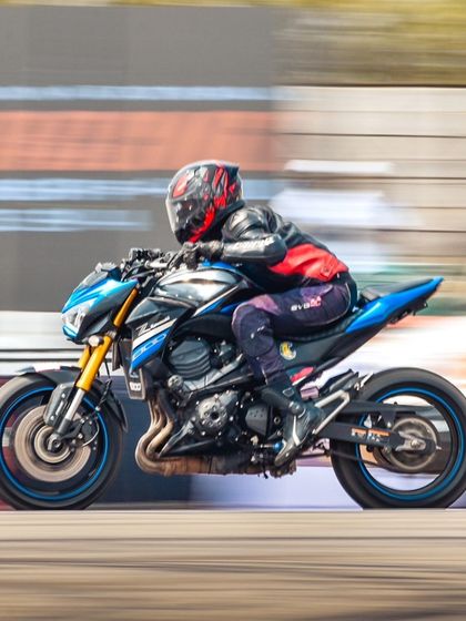 A second shot of the blue Kawasaki Z800, its powerful engine and aggressive styling on full display as it blurs down the track.