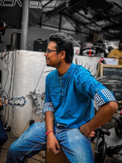 A musician relaxes between sets at the Garage Sale. The live music adds a special touch to the event's atmosphere.