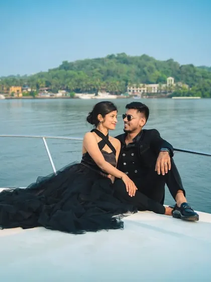 Your love story deserves an adventure. We plan exclusive destination photoshoots, like this luxury yacht session in Goa, to capture your bond against stunning sea views for a truly glamorous experience.