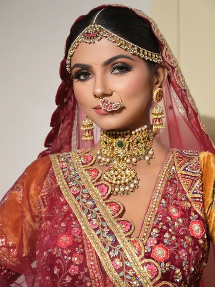 A direct, powerful gaze. This close-up captures the intensity of the eye makeup and the richness of the traditional jewelry, creating a look of pure confidence.