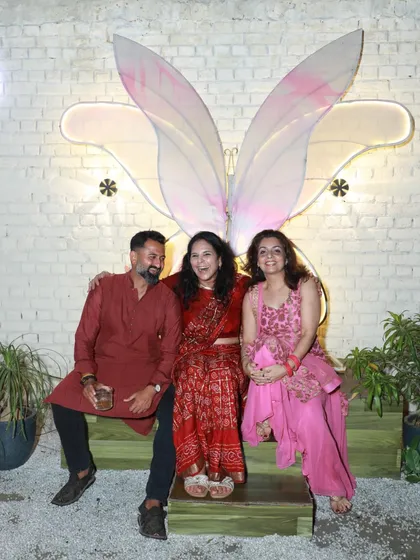 Guests posing in front of our butterfly wing installation. I added this piece to be a fun and beautiful backdrop for your photos and memories.