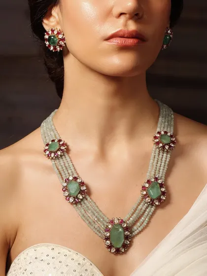 A delicate yet regal necklace from the Emrosia collection, featuring a multi-strand design with floral emerald and ruby motifs.