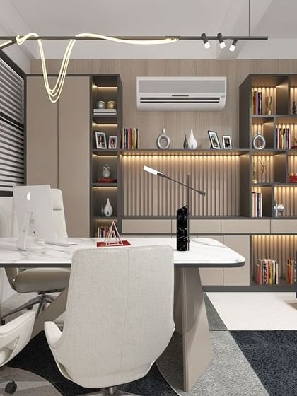 This office for Gigatel features a comfortable lounge area with a blue sofa, complemented by warm wood paneling and modern lighting, creating a perfect space for informal meetings.