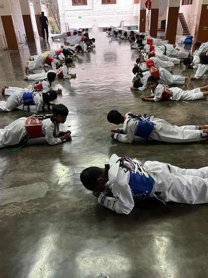 Core strength is non-negotiable in Taekwondo. My students are holding a plank, an exercise that builds the stamina and stability required for powerful kicks and a strong defense.