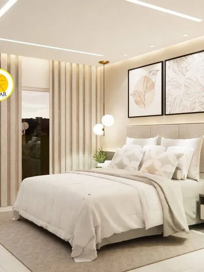 A serene bedroom with a light and airy feel. The design features simple artwork, globe pendant lights, and a soft, neutral color palette.