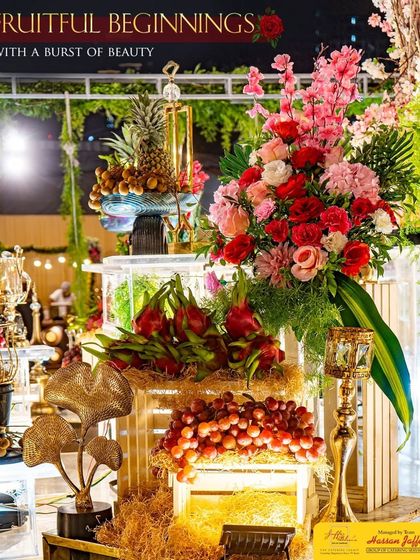 Fruitful beginnings with a burst of beauty. This stunning arrangement features pineapples, dragon fruit, and grapes, complemented by vibrant floral bouquets.