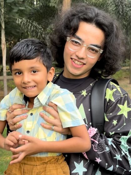 Our community is for all ages. A poet shares a happy moment with a young boy during a park shoot, showing the inclusive and friendly nature of our tribe.