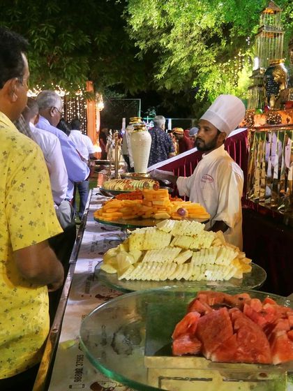 A display of fresh fruits and starters at a buffet. I believe in offering a balanced menu that includes healthy and refreshing options like watermelon and various salads.