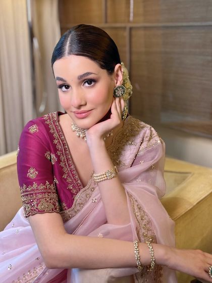 A serene portrait of the bride on her first Karwa Chauth, her glowing makeup and traditional jewelry perfectly complementing her elegant saree.