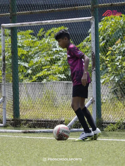 A player focuses on the ball at their feet, demonstrating control and composure.