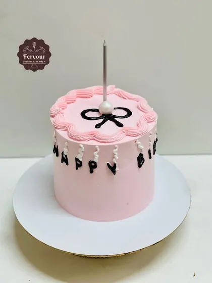 A simple pink cake with minimal design. This chocolate truffle cake shows that even a simple request can be made beautifully, focusing on clean lines and great taste.