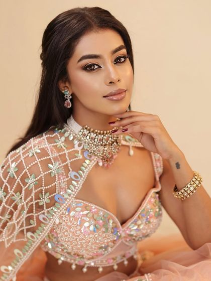 A confident portrait of the client, her makeup looking flawless and her pose exuding elegance.