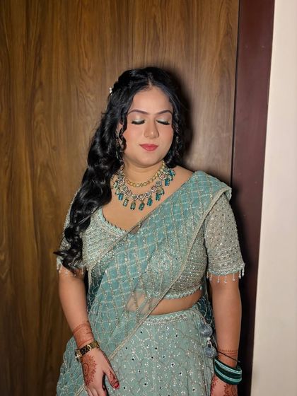 A close-up with eyes closed, showing the blended eyeshadow and wavy hairstyle.