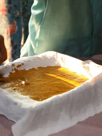 A participant at one of our workshops gets hands-on with natural dye paste. We provide all the materials and guidance for you to explore your creativity with plant-based colors.
