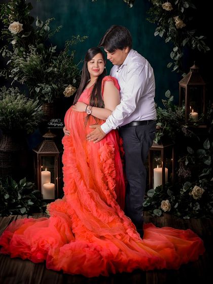 A romantic and cozy studio scene with warm candlelight and lush greenery. This setup is perfect for a couple's portrait that feels both intimate and elegant.