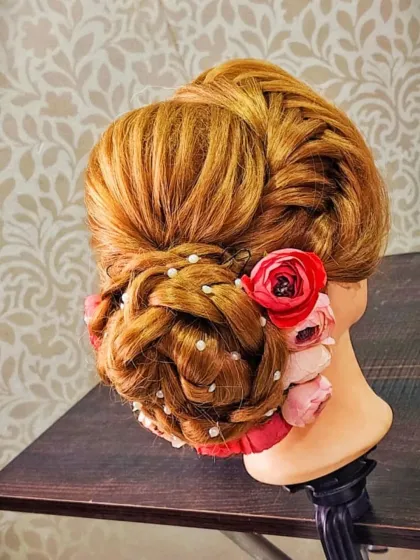 A beautifully constructed bun with floral and pearl accents, showing the clean lines and structure of a professional updo.
