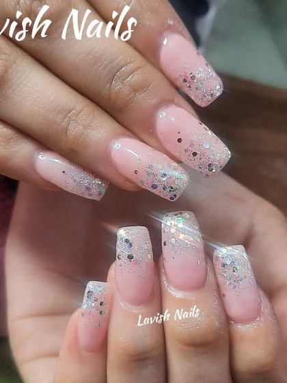 A classic chunky silver glitter fade on a sheer pink base for a timeless party look.