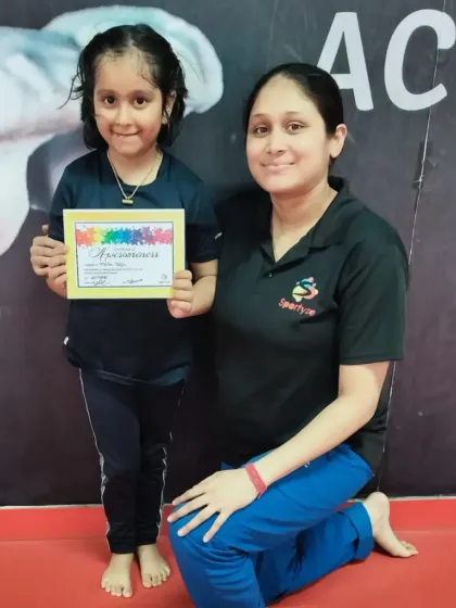 This little gymnast proudly shows off her "Awesomeness" certificate.