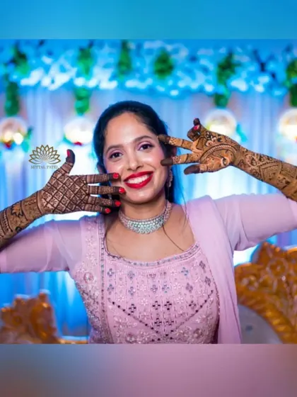 A playful and happy bride, her mehndi-adorned hands adding to her joyful expression. It’s wonderful to see my clients so happy with their designs.