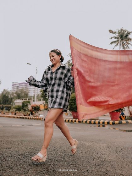 A fun, candid shot of the bride running with her saree, capturing her excitement and joyful spirit.
