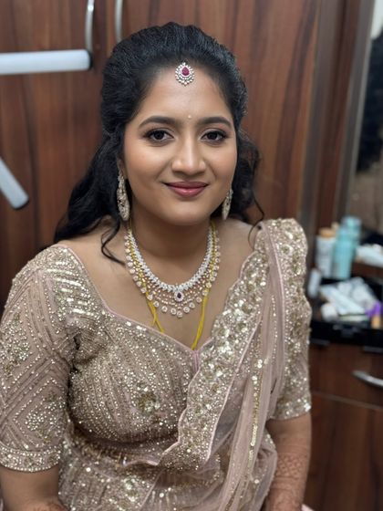 My beautiful bride Preetha from Bangalore, looking elegant for her reception. Her glam makeup features soft, glowing skin and a defined eye, paired with a sparkling diamond necklace.