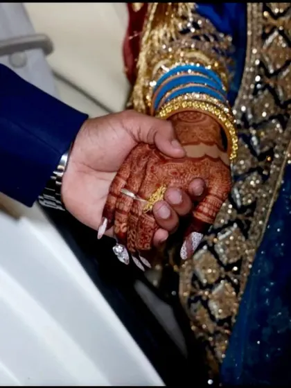 A special moment between the bride and groom, highlighting her lovely dark henna stain. It's such an important detail of the wedding day.