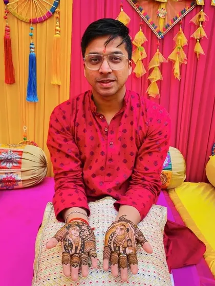 Another shot of the groom's portrait mehendi, showcasing the detailed artwork against a festive backdrop.