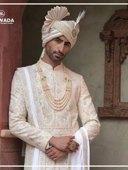 The groom looks on with a gentle smile, his attire a perfect blend of majesty and grace. The Shauhar collection is designed to make you feel like the king of your special day.