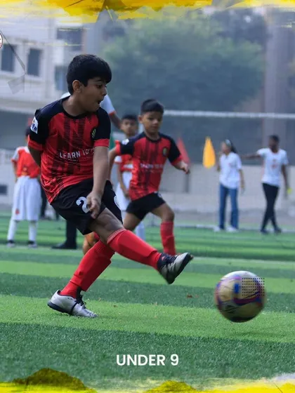 A player from our U9 team takes a powerful shot on goal during a friendly match.